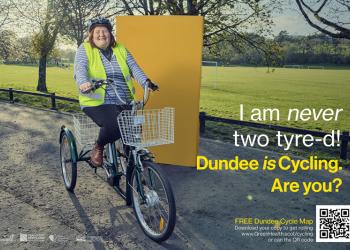 Woman on electric tricycle with high visibility vest