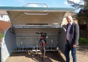 Cycle locker and Cllr Mark Flynn