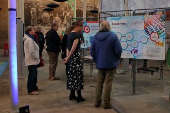 People standing in a row reading boards of information